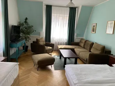 a living room with a couch and chairs and a tv at Residence u Vejvodů in Prague