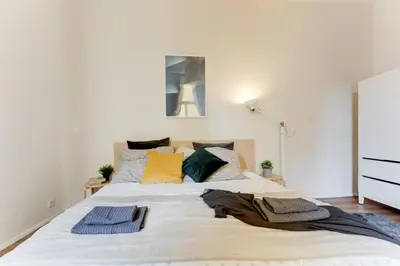 a large white bed with pillows on top of it at New & cozy 3Bds in Historical Center - S8 in Prague