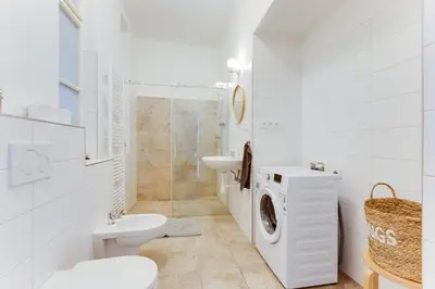 a white bathroom with a toilet sink and a washing machine at New & cozy 3Bds in Historical Center - S8 in Prague