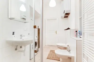 a white bathroom with a sink and a toilet at New & cozy 3Bds in Historical Center - S8 in Prague