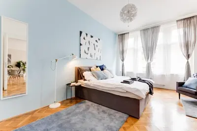 a bedroom with a bed and a living room at New & cozy 3Bds in Historical Center - S8 in Prague
