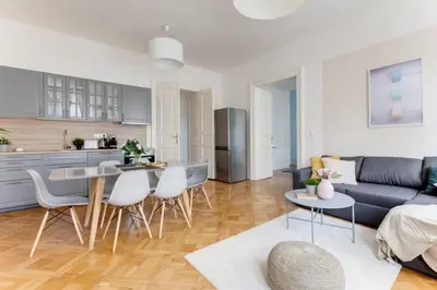 a living room with a couch and a table and chairs at New & cozy 3Bds in Historical Center - S8 in Prague