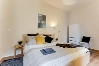 a bedroom with a large white bed with yellow pillows at New & cozy 3Bds in Historical Center - S8 in Prague