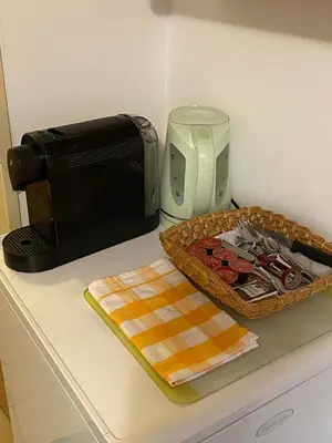 a kitchen counter with a microwave and a basket of food at Apartment Trojska in Prague