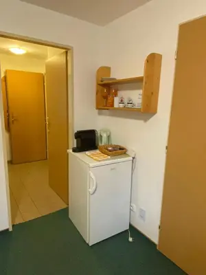 a room with a small refrigerator in a room at Apartment Trojska in Prague