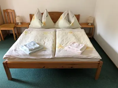 a bed with two pillows and two towels on it at Apartment Trojska in Prague