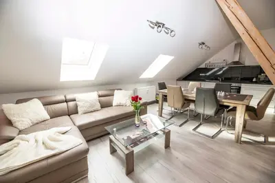 a living room with a couch and a table at VIP suite hotel Heinz in Dobříš