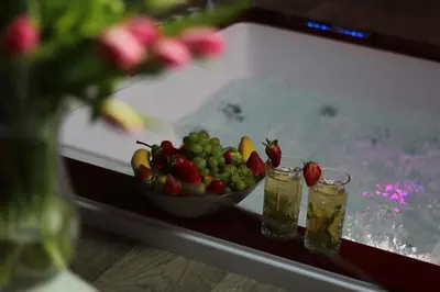 a bowl of fruit sitting on a table with drinks at VIP suite hotel Heinz in Dobříš