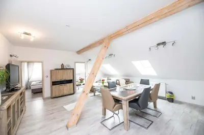 a dining room and living room with a table and chairs at VIP suite hotel Heinz in Dobříš