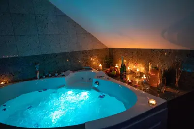 a large blue tub in a room with lights at VIP suite hotel Heinz in Dobříš