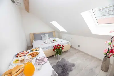 a small room with a bed and a table with food at VIP suite hotel Heinz in Dobříš