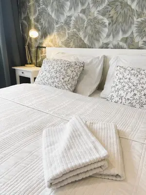 a white bed with two pillows on top of it at Apt 100 Prague in Prague