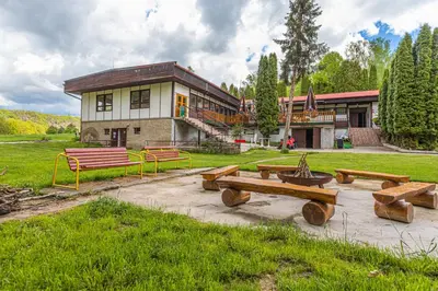 a building with a bunch of benches in front of it at Kemp Andělská laguna Slapy in Nalžovice