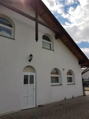 a white house with a white door and windows at Penzion Cerhenice in Cerhenice