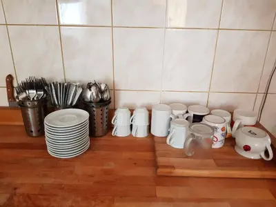 a group of white cups and plates on a counter at Penzion Cerhenice in Cerhenice