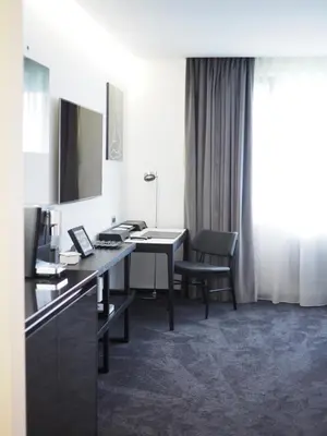 a chair and a side table in a room at Apartman Grey in Prague