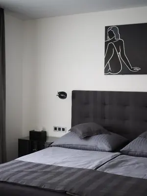 a living room with two tables and a television on the wall at Apartman Grey in Prague