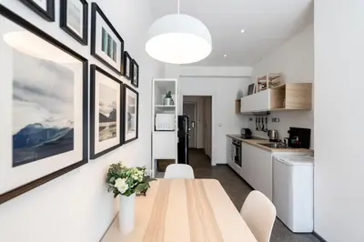 a kitchen and dining room with a wooden table at Apartment Slavikova 11 in Prague