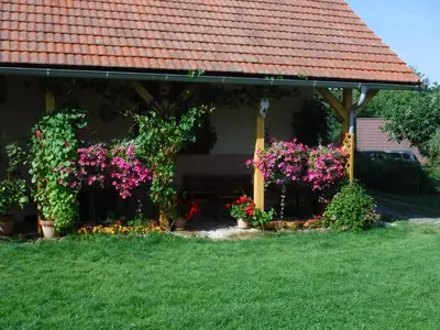 a gazebo with flowers and plants in a yard at Farma Zahradnice in Olbramovice Ves