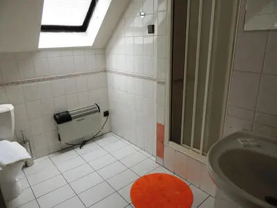 a bathroom with a sink and a shower and a toilet at Penzion Pohoda Beroun in Beroun