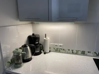 a kitchen counter with a coffeemaker and a coffee maker at Tulip Apartment in Prague