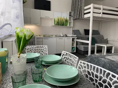 a living room with a table with green plates on it at Tulip Apartment in Prague