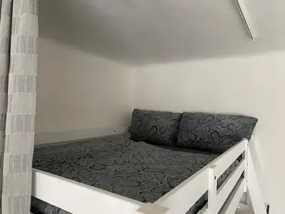 a small bed in a small room at Tulip Apartment in Prague