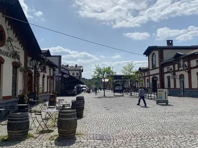a man walking down a street in a town at Tulip Apartment in Prague