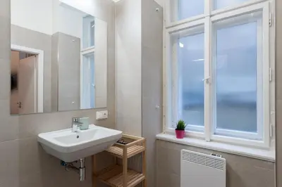a bathroom with a sink and a window at Tesnov Residence Apartments in Prague