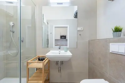 a bathroom with a sink and a shower at Tesnov Residence Apartments in Prague