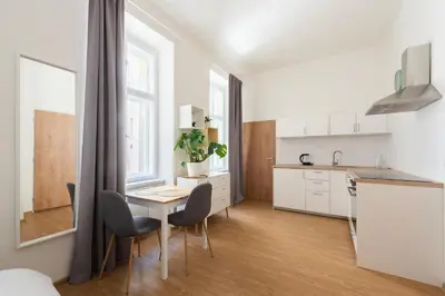 a kitchen and dining room with a table and chairs at Tesnov Residence Apartments in Prague