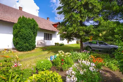 a house with a car parked in the yard at Šafářův statek Milovice in Milovice