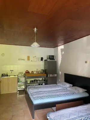 a room with two beds and a kitchen at Šafářův statek Milovice in Milovice