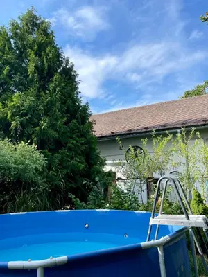 a blue pool in front of a house at Šafářův statek Milovice in Milovice