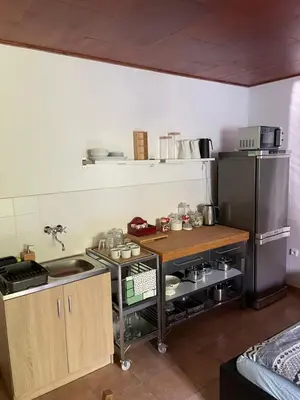 a kitchen with a stove and a refrigerator at Šafářův statek Milovice in Milovice