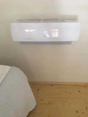 a white air conditioner on a wall in a bedroom at Apartment Nebovidy II - Air Conditioning - Historic City Center in Prague