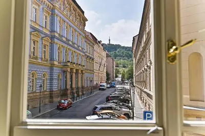 a view from a window of a street with parked cars at Apartment Nebovidy II - Air Conditioning - Historic City Center in Prague