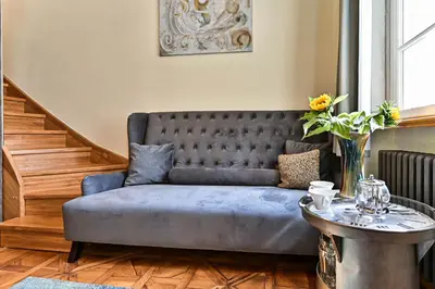 a living room with a couch and a table at Apartment Nebovidy II - Air Conditioning - Historic City Center in Prague