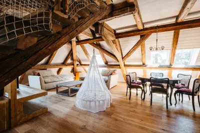 a living room with a table and chairs at Boutique hotel Corso in Řevnice