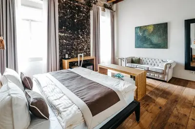 a bedroom with a bed and a couch at Boutique hotel Corso in Řevnice