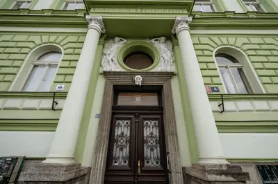 a front door of a building with columns at Prague Days - Minimalistic Studio with Netflix and View to National Museum in Prague
