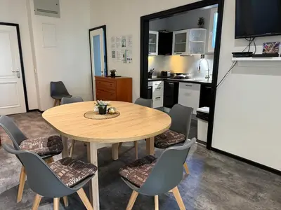 a kitchen and dining room with a table and chairs at Apartmán Kaiser in Prague
