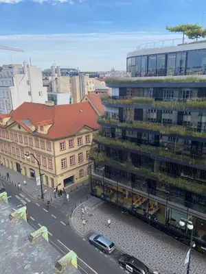 a city street with a tall building with plants on it at Apartmán Kaiser in Prague