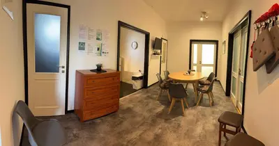 a room with a desk and a table and chairs at Apartmán Kaiser in Prague