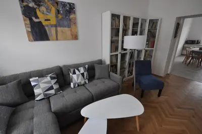 a living room with a gray couch and a table at Jiřina Appartments in Prague