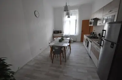 a small kitchen with a table and a refrigerator at Jiřina Appartments in Prague