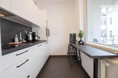 a bedroom with a large bed with a flat screen tv at Stay Inn Apartments Krakovska in Prague