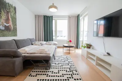 a bedroom with a bed and a couch at Stay Inn Apartments Krakovska in Prague