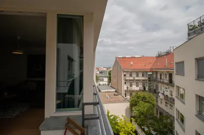 a living room with a couch and a tv at Stay Inn Apartments Krakovska in Prague