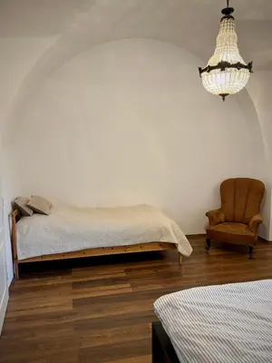 a bedroom with a red bed and a window at Budyne Apartment II. in Budyně nad Ohří